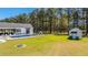 Inviting backyard with in-ground pool, covered patio and cabana near wooded area at 161 Ryefield Ln, Ridgeville, SC 29472