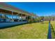 Lush green backyard featuring a covered patio with an outdoor kitchen, grill and games at 161 Ryefield Ln, Ridgeville, SC 29472