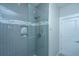 Modern tiled shower featuring glass door and niche for toiletries adds spa-like experience to primary bathroom at 161 Ryefield Ln, Ridgeville, SC 29472