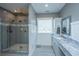 Stylish bathroom featuring marble countertops, a sleek shower, and ample natural light at 161 Ryefield Ln, Ridgeville, SC 29472