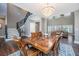 Open dining room with hardwood floors, a chandelier, and seamless connection to the living area at 161 Ryefield Ln, Ridgeville, SC 29472