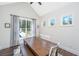 Bright dining space with rustic table, white chairs and curtains, and views of the yard at 161 Ryefield Ln, Ridgeville, SC 29472