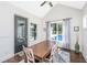Cozy dining area with a wooden table, white chairs, and a view of the outdoor pool at 161 Ryefield Ln, Ridgeville, SC 29472