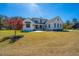 Beautiful two-story home with a well-manicured lawn, complemented by a vibrant red maple tree at 161 Ryefield Ln, Ridgeville, SC 29472