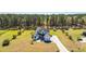 Stunning two-story home featuring a large lawn, a private driveway, and complemented by verdant, mature trees at 161 Ryefield Ln, Ridgeville, SC 29472