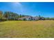 Sprawling lawn surrounds this lovely, white two-story home under a bright blue sky at 161 Ryefield Ln, Ridgeville, SC 29472