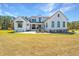 Charming two-story farmhouse with black trim, a cozy porch, and a manicured lawn at 161 Ryefield Ln, Ridgeville, SC 29472