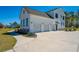 White three-car garage and concrete driveway of a lovely two-story home on a beautiful, sunny day at 161 Ryefield Ln, Ridgeville, SC 29472