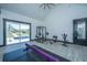 Home gym featuring exercise equipment, vaulted ceilings, and tile flooring with natural light at 161 Ryefield Ln, Ridgeville, SC 29472