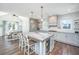 Bright kitchen features large island with seating, stylish lighting, and stainless appliances at 161 Ryefield Ln, Ridgeville, SC 29472