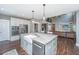 Well-equipped kitchen features stainless steel appliances, farmhouse sink and island with seating at 161 Ryefield Ln, Ridgeville, SC 29472