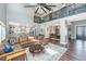 Stylish living room with leather sectional, open kitchen, and views to the dining room at 161 Ryefield Ln, Ridgeville, SC 29472