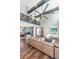 Open living space with a cozy leather sectional, modern ceiling fan, and dining area at 161 Ryefield Ln, Ridgeville, SC 29472