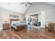 Spacious main bedroom features vaulted ceiling, wood floors, and sliding door to the screened porch at 161 Ryefield Ln, Ridgeville, SC 29472