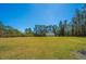 Large backyard featuring a metal outbuilding, perfect for storage or a workshop at 161 Ryefield Ln, Ridgeville, SC 29472
