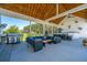Covered outdoor patio with comfortable seating, a dining area, ceiling fans, and a grill at 161 Ryefield Ln, Ridgeville, SC 29472