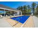 Beautiful backyard pool area with a slide, covered patio, outdoor kitchen, and lounge chairs at 161 Ryefield Ln, Ridgeville, SC 29472