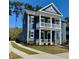 Inviting two-story home featuring a charming porch and a well-maintained lawn at 1659 Seabago Dr, Charleston, SC 29414