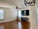 Spacious living room featuring hardwood floors, a ceiling fan, and a modern light fixture at 1659 Seabago Dr, Charleston, SC 29414