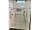 Modern bathroom shower with sliding glass door, white subway tile, and a built-in niche at 1659 Seabago Dr, Charleston, SC 29414
