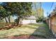Large backyard with wooden fence featuring a patio area, lush lawn, and mature trees at 1706 W Avalon Cir, Charleston, SC 29407