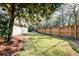 Spacious backyard with a wooden fence, providing privacy and a charming outdoor space at 1706 W Avalon Cir, Charleston, SC 29407