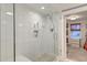 Modern walk-in shower with white subway tile and glass enclosure and view to the walk-in closet at 1706 W Avalon Cir, Charleston, SC 29407