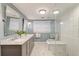 Modern bathroom featuring a double vanity, a walk-in shower and tiled floors at 1706 W Avalon Cir, Charleston, SC 29407