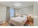 Comfortable bedroom featuring a queen bed, bedside tables, and ample natural light from the large window at 1706 W Avalon Cir, Charleston, SC 29407