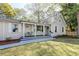 Charming home featuring a cozy front porch with seating and manicured landscaping at 1706 W Avalon Cir, Charleston, SC 29407