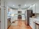 Spacious kitchen features hardwood floors, stainless appliances, and white cabinetry for a clean, modern feel at 1706 W Avalon Cir, Charleston, SC 29407