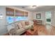 Cozy living room featuring large windows with woven shades and comfortable seating at 1706 W Avalon Cir, Charleston, SC 29407