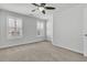 This bedroom has carpet flooring, light walls, two windows and a ceiling fan at 1808 Chauncys Ct, Mount Pleasant, SC 29466
