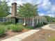 Community clubhouse with brick detailing, white columns, and manicured landscaping, offering an inviting space for residents at 1808 Chauncys Ct, Mount Pleasant, SC 29466