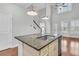 Modern kitchen island with granite countertop, stainless steel sink, and stylish pendant lighting at 1808 Chauncys Ct, Mount Pleasant, SC 29466