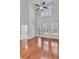 Living room featuring high ceilings, hardwood floors, white plantation shutters, and a ceiling fan at 1808 Chauncys Ct, Mount Pleasant, SC 29466