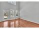 Open living room with hardwood floors and natural light from white framed windows at 1808 Chauncys Ct, Mount Pleasant, SC 29466