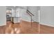 Hardwood floors lead to a modern kitchen with stainless appliances, island, and a staircase at 1808 Chauncys Ct, Mount Pleasant, SC 29466