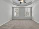 Spacious carpeted main bedroom with tray ceiling, ceiling fan, and plantation shuttered windows at 1808 Chauncys Ct, Mount Pleasant, SC 29466