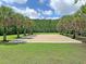 Sand volleyball court surrounded by grass and palm trees at 1808 Chauncys Ct, Mount Pleasant, SC 29466