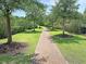 Scenic brick walking path surrounded by green grass and trees at 1808 Chauncys Ct, Mount Pleasant, SC 29466