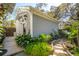 Charming backyard studio with a stone pathway and meticulously landscaped tropical plants and manicured garden beds at 1810 Fleming Woods Rd, Charleston, SC 29412