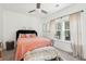 Charming bedroom with a bed adorned with pillows and a plush bench seat, bathed in light at 1810 Fleming Woods Rd, Charleston, SC 29412