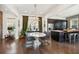 Bright dining area with dark hardwood floors, modern light fixture, and an adjacent open-concept kitchen at 1810 Fleming Woods Rd, Charleston, SC 29412