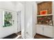 Inviting entryway with a convenient bar area featuring brick wall and sleek cabinetry at 1810 Fleming Woods Rd, Charleston, SC 29412