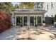 Charming two-car garage with decorative doors and neatly arranged potted plants at 1810 Fleming Woods Rd, Charleston, SC 29412