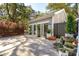 Detached two-car garage featuring stylish doors, potted greenery, and ample driveway space at 1810 Fleming Woods Rd, Charleston, SC 29412