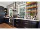 Well-lit kitchen with stainless steel appliances, a stylish backsplash, and open shelving for a modern feel at 1810 Fleming Woods Rd, Charleston, SC 29412