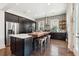 Stylish kitchen featuring dark cabinetry, a butcher block island with seating, and stainless steel appliances at 1810 Fleming Woods Rd, Charleston, SC 29412