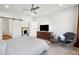 Serene main bedroom featuring stylish furniture, ceiling fan, and barn door to the bathroom at 1810 Fleming Woods Rd, Charleston, SC 29412